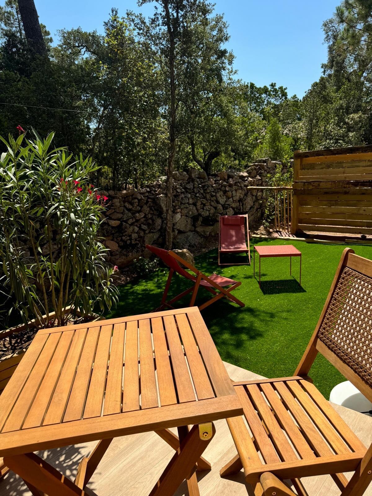 Table et chaises en bois dans le jardin, sous les arbres