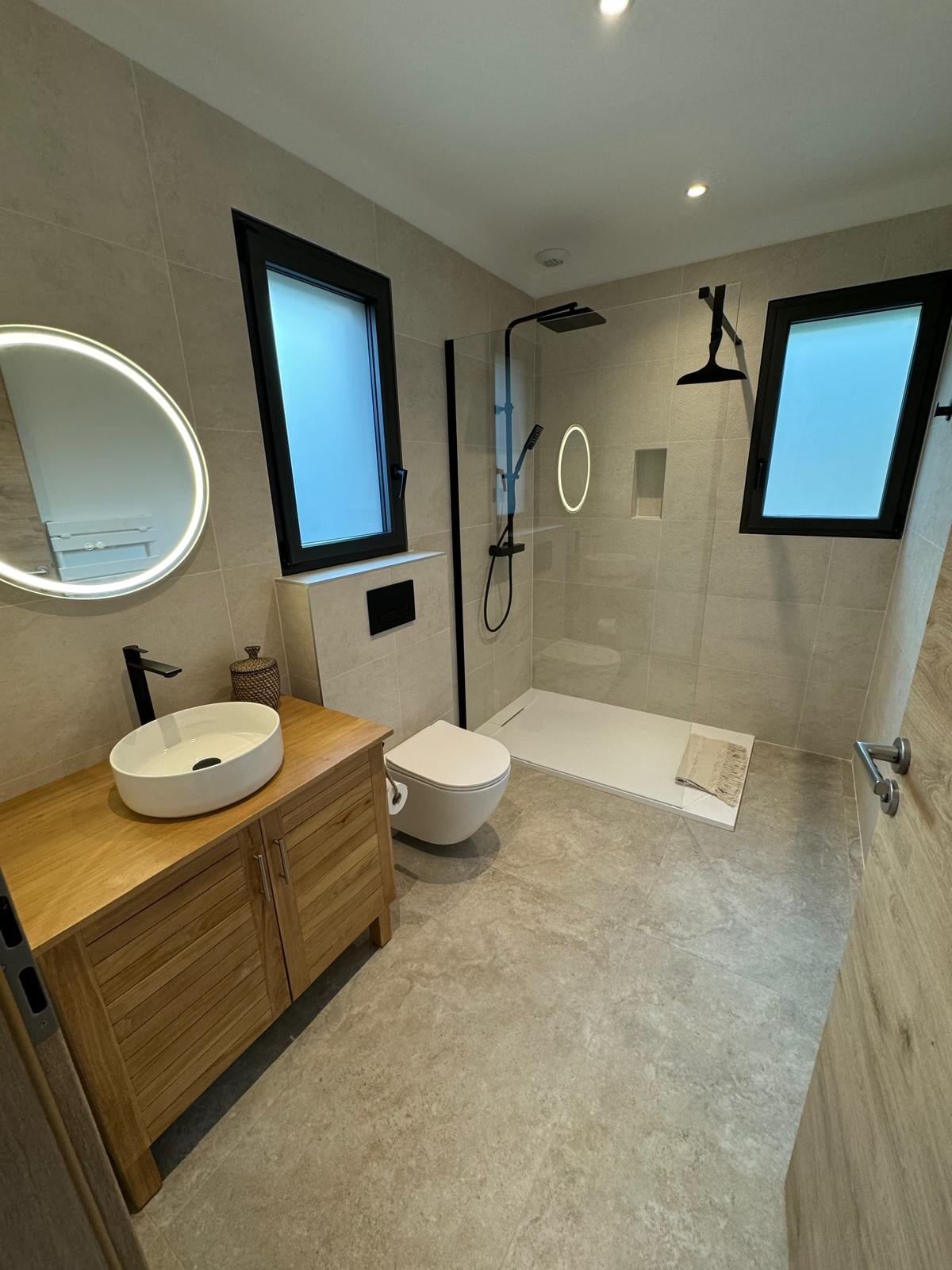 Shower room with basin on a wooden unit and walk-in shower