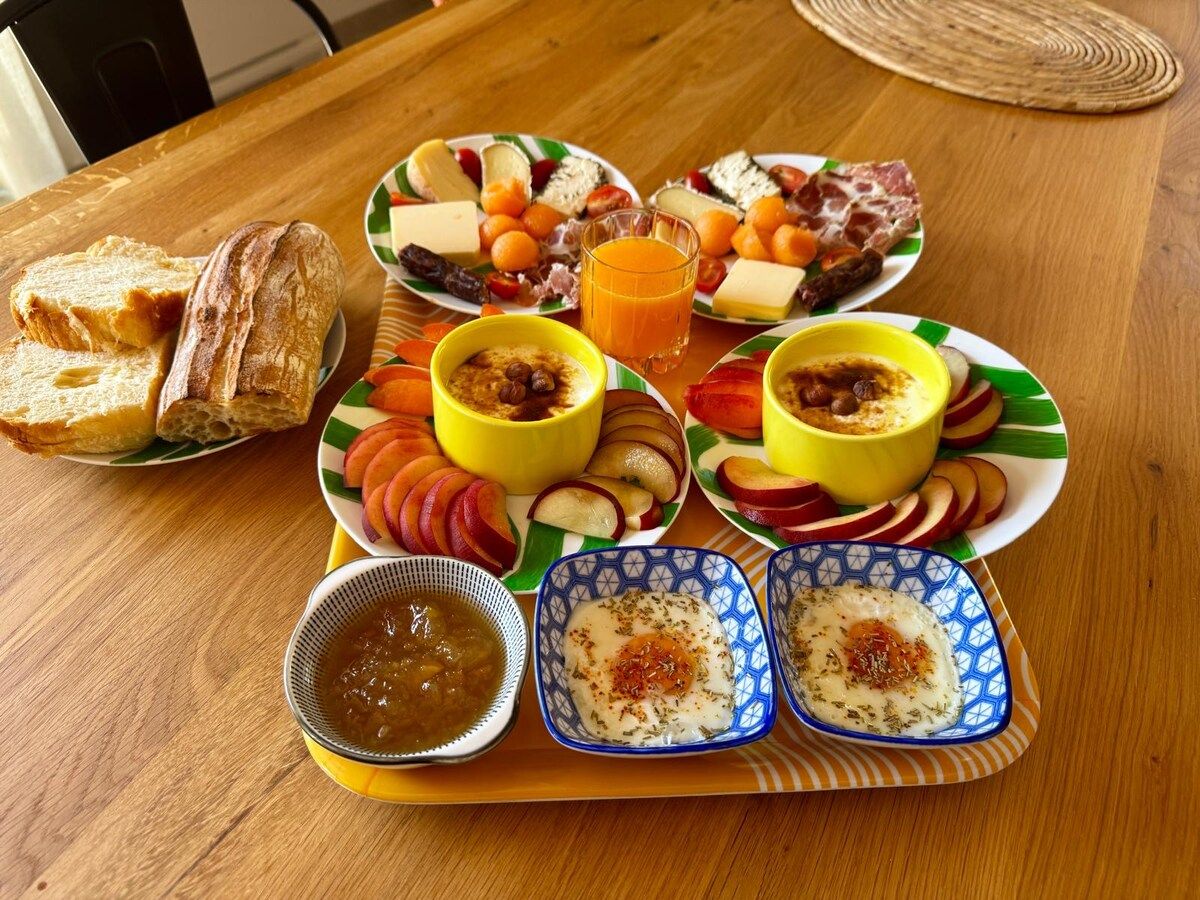 Homemade breakfast: fresh fruit, cheeses, charcuterie, flans, bread and orange juice