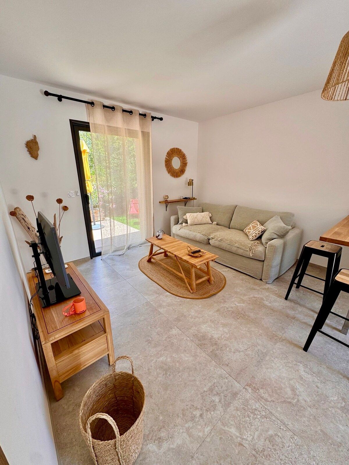 Seating area with sofa bed, wooden coffee table and TV