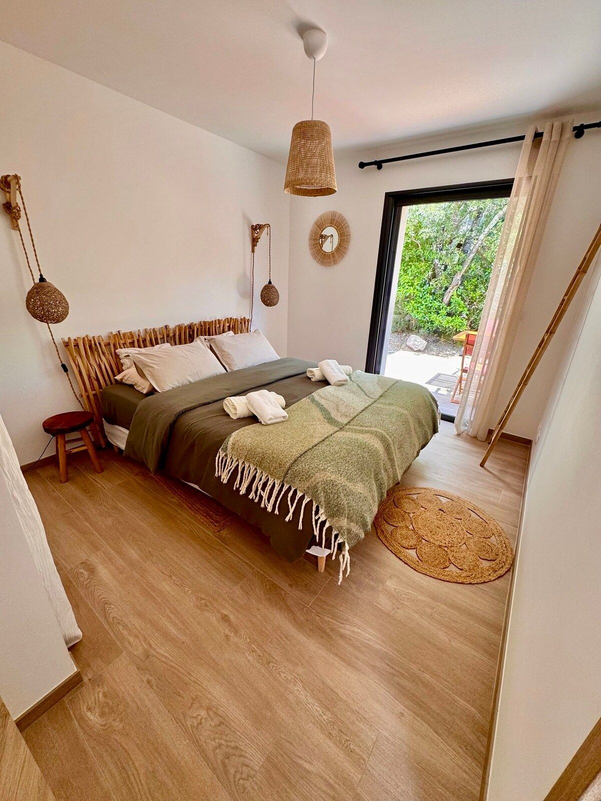 Bedroom with rattan pendant light and French window